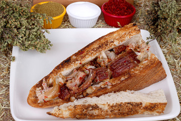 close up of colorful spicy kokorec on white plate