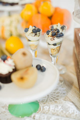 Sweet table. Halloween Wedding Luxor Decor. Dessert, cupcake, pears. Surrounded by orange pumpkins