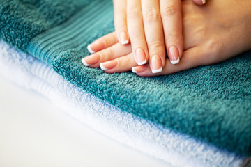 Fototapeta premium Nails care. Beautiful woman's nails with french manicure, in beauty studio