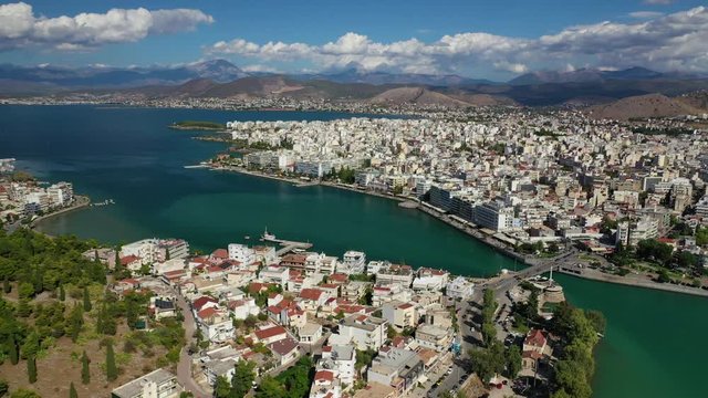 Aerial drone video of iconic town of Halkida or Chalkida with famous old bridge connecting Evoia island with mainland and beautiful clouds, Greece