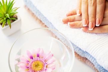 Obraz na płótnie Canvas Nails care. Beautiful woman's nails with french manicure, in beauty studio