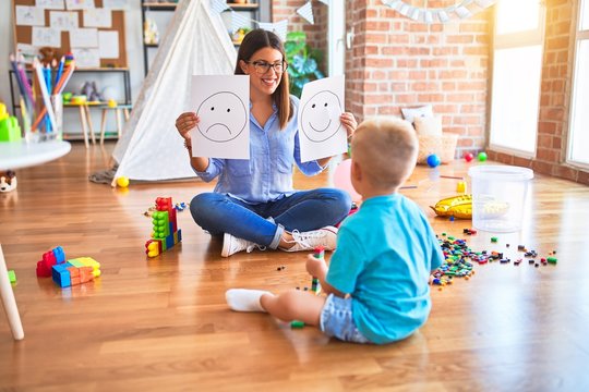 Young Therapist Woman Speaking With Child, Counselor And Behaviour Correction At The Office Showing Happy And Sad Face