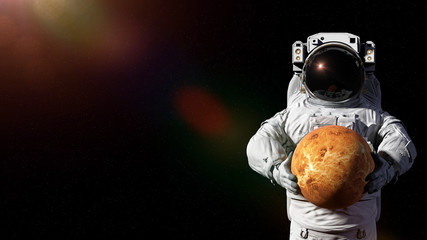 astronaut holding planet Venus © dottedyeti
