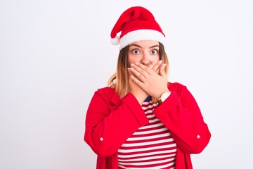 Young beautiful woman wearing Christmas Santa hat over isolated white background shocked covering mouth with hands for mistake. Secret concept.