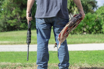 Conservative Caucasian Man Holding AR-15 Automatic Assault Rifle And American Flag Under...