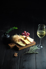 Glass of cold white wine with cheese snack on a wooden. catering menu