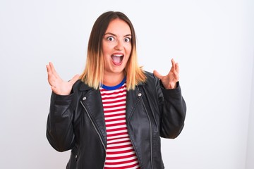 Young beautiful woman wearing striped shirt and jacket over isolated white background celebrating crazy and amazed for success with arms raised and open eyes screaming excited. Winner concept