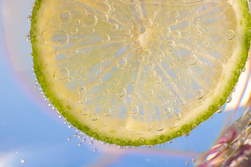 slice of lemon in the water with bubbles