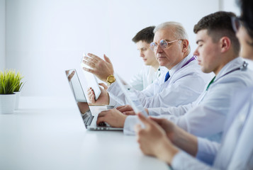 Medical team sitting and discussing at table