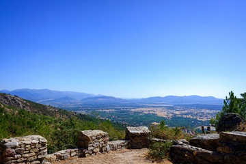 Fototapeta na wymiar View from a medieval fortress of the Guadarrama valley in Madrid with its mountains in the background.