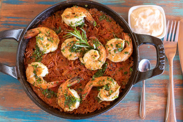Stir fry with udon noodles, shrimps (prawns). Asian healthy food, meal, stir fry in wok over black background, copy space.