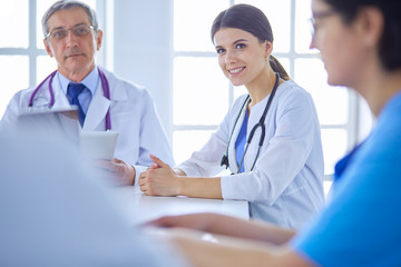 Fototapeta premium Serious medical team discussing patient's case in a bright office