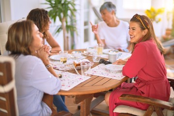 Young beautiful girl smiling happy and confident sitting dinking cup of coffee at terrace