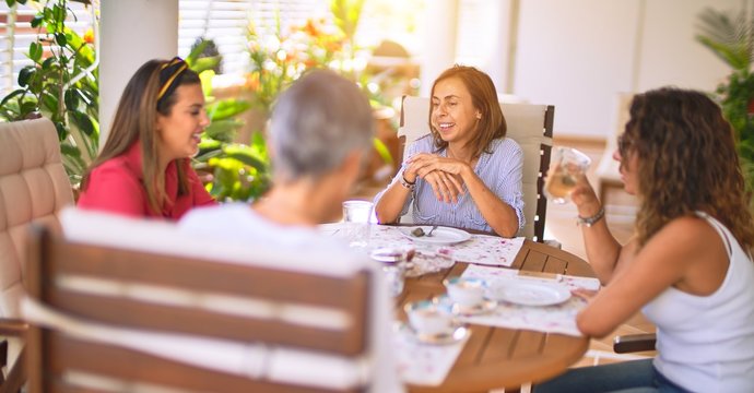 Young beautiful girl smiling happy and confident sitting dinking cup of coffee at terrace