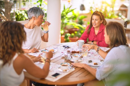 Young beautiful girl smiling happy and confident sitting dinking cup of coffee at terrace