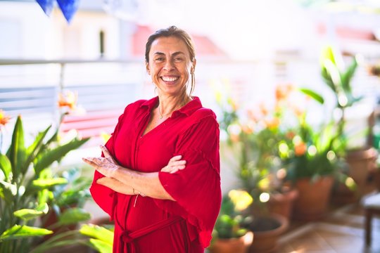 Middle age beautiful woman smiling happy and confident standing with a smile on face at terrace