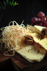 Glass of cold white wine with cheese snack on a wooden. catering menu