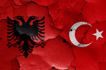 flags of Albania and Turkey painted on cracked wall