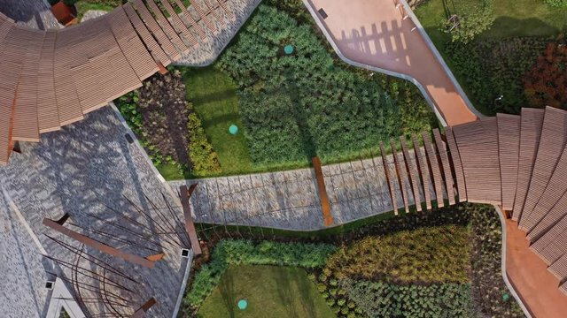 Picturesque drone aerial zoom out view of paths of Park Tiufielieva Roshcha in Moscow, Russia. Park ZILART in the south of Moscow