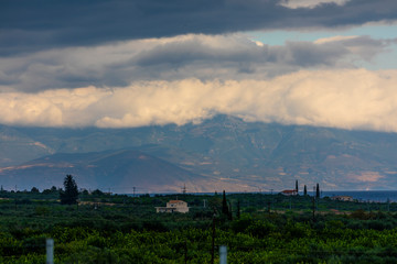 A mountain range in Greece covered in low hanging cloud.