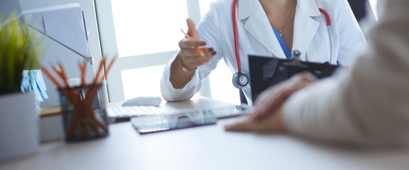 Female doctor holding application form while consulting patient