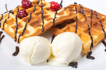 Viennese waffles with ice cream, chocolate and cherry. Close-up. Background