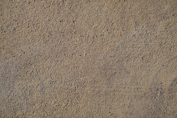 Empty and even texture of cement surface, empty space in warm side light.