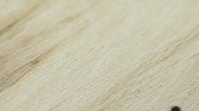 Cumin seeds falls on the wooden board