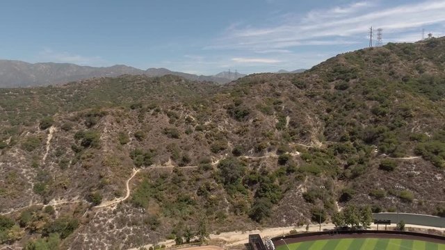 Aerial shot over soccer field and mountains in Glendale, California
