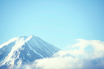 Top of Fujiyama mountain with snow covered over blue sky