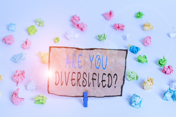 Text sign showing Are You Diversified Question. Business photo text someone who is Different Mixed Multi Faceted Colored crumpled papers empty reminder white floor background clothespin