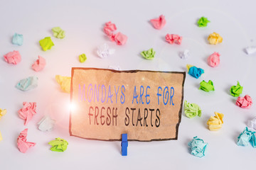 Text sign showing Mondays Are For Fresh Starts. Business photo text Begin again every week have a good morning Colored crumpled papers empty reminder white floor background clothespin