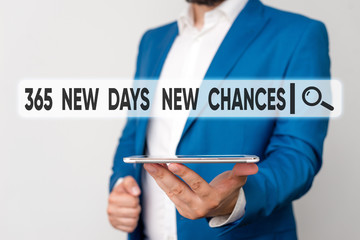 Text sign showing 365 New Days New Chances. Business photo showcasing Starting another year Calendar Opportunities Man in the blue suite and white shirt holds mobile phone in the hand