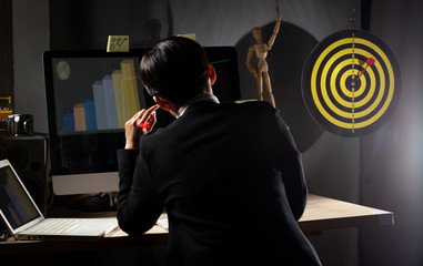 Business tomboy set dartboard as top Target and hand on computer keyboard in late night, LGBT...