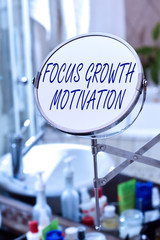 Handwriting text Focus Growth Motivation. Conceptual photo doing something with accuracy increase productivity Round shape mirror and toiletries placed next to sink in a modern bathroom