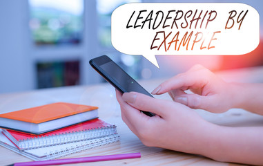 Conceptual hand writing showing Leadership By Example. Concept meaning Becoming role model for...
