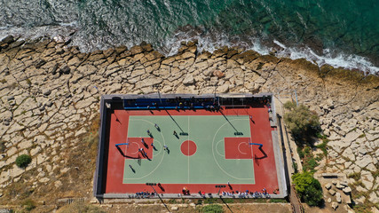 Aerial top down photo of seaside outdoor basketball court with team competing in Mediterranean popular destination © aerial-drone