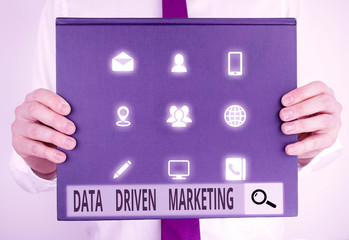 Text sign showing Data Driven Marketing. Business photo text Strategy built on Insights Analysis from interactions Male human holding thick textured cardboard of business promotion concept