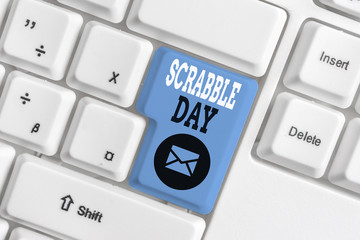 Conceptual hand writing showing Scrabble Day. Concept meaning a day to celebrate the popular board game created in 1938 White pc keyboard with note paper above the white background