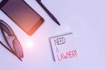 Handwriting text writing Need A Lawyer Question. Conceptual photo Legal problem Looking for help from an attorney Eyeglasses colored sticky note smartphone cell pen cool pastel background