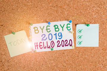 Handwriting text Bye Bye 2019 Hello 2020. Conceptual photo Starting new year Motivational message 2019 is over Corkboard color size paper pin thumbtack tack sheet billboard notice board © A