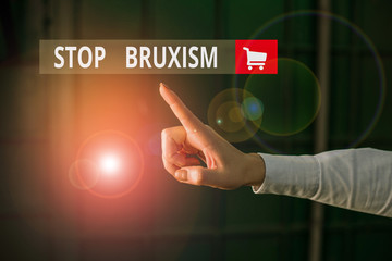 Word writing text Stop Bruxism. Business photo showcasing put an end to a condition which you grind or clench the teeth Finger pointing in the Dark with hand pointing in the copy space