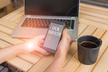 Writing note showing Our Services. Business concept for The occupation or function of serving Intangible products woman with laptop smartphone and office supplies technology