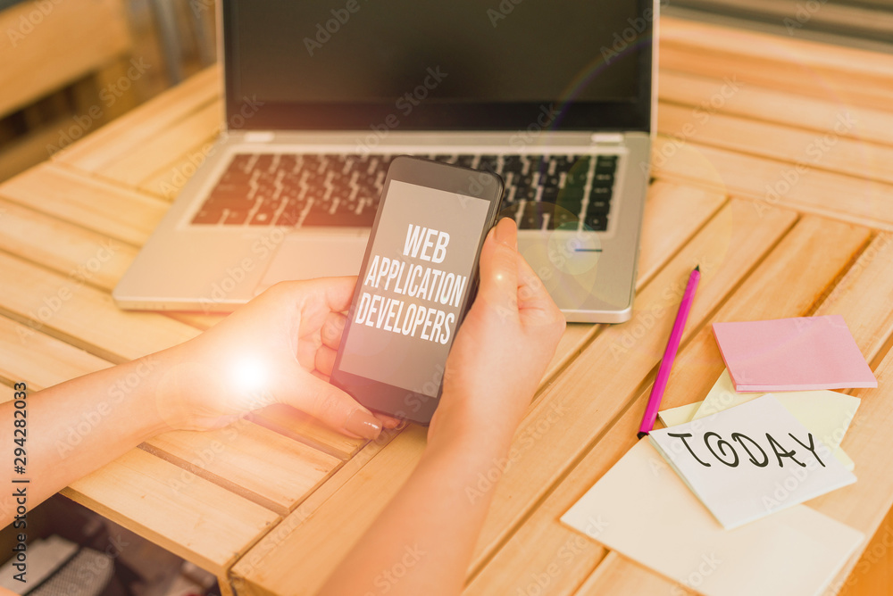Poster Text sign showing Web Application Developers. Business photo showcasing Internet programming experts Technology software woman laptop computer smartphone office supplies technological devices