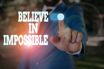 Text sign showing Believe In Impossible. Business photo text You can do it everything is possible Work hard Male human wear formal work suit presenting presentation using smart device
