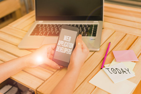 Text sign showing Web Application Developers. Business photo showcasing Internet programming experts Technology software woman laptop computer smartphone office supplies technological devices