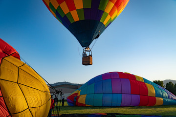 Colorful hot air balloons getting ready to lift off in Grants Pass Oregon on a beautiful summer morning