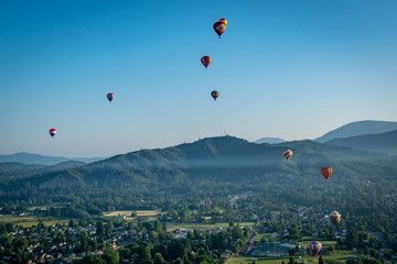 Colorful hot air balloons over Grants Pass Oregon on a beautiful summer morning