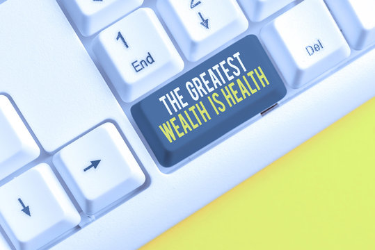 Conceptual hand writing showing The Greatest Wealth Is Health. Concept meaning being in good health is the prize Take care White pc keyboard with note paper above the white background
