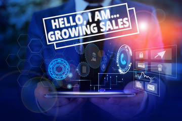 Conceptual hand writing showing Hello I Am Growing Sales. Concept meaning Making more money Selling larger quantities Male wear formal suit presenting presentation smart device